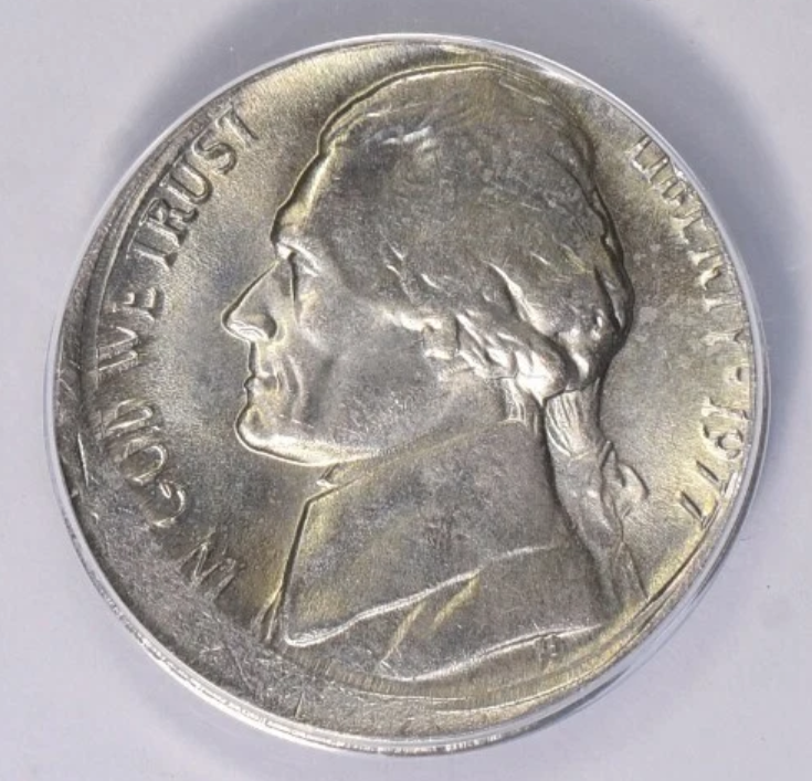 1977 nickel off-center strike error showing design shifted 40-50% with visible blank planchet crescent and date still readable