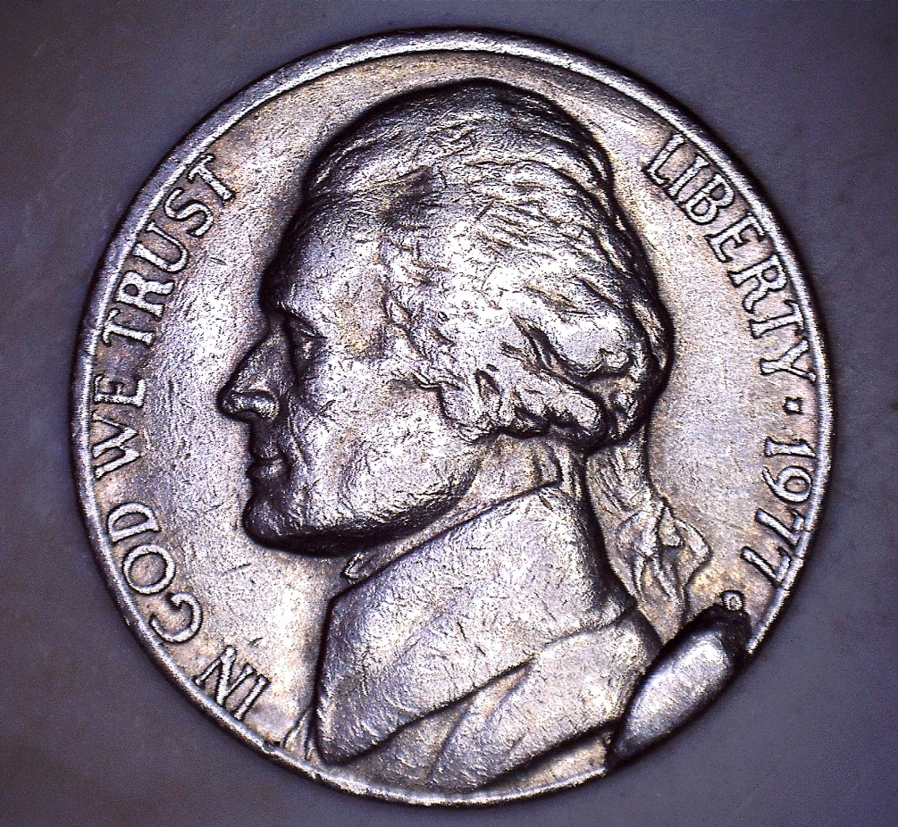 1977 nickel die cud error showing raised blob of blank metal along the coin rim from a broken die