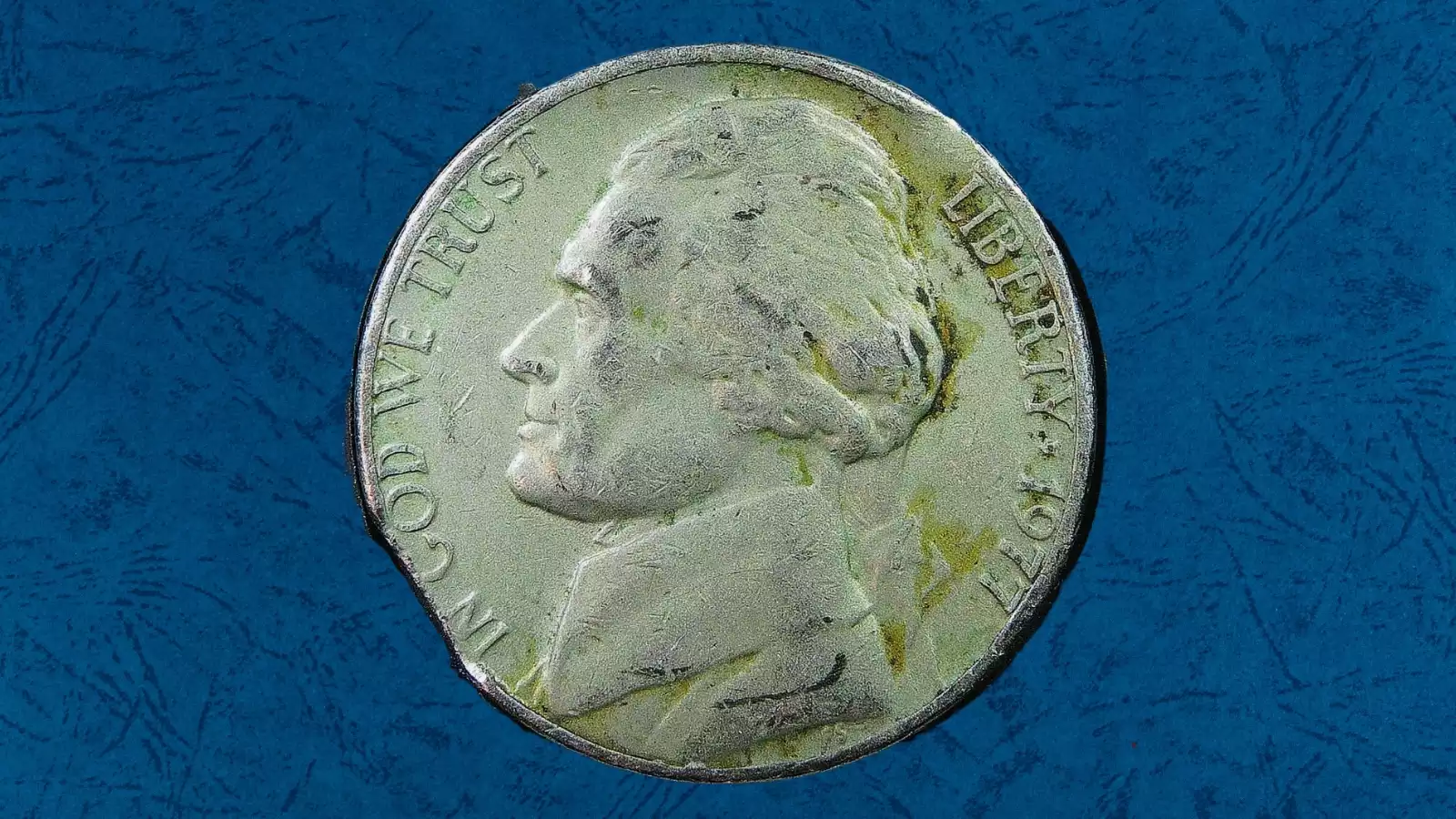 1977 nickel clipped planchet error showing curved section of missing metal on coin edge